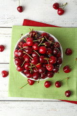 Sweet cherries in bowl on table close up