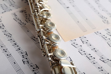 Flute on music notes background
