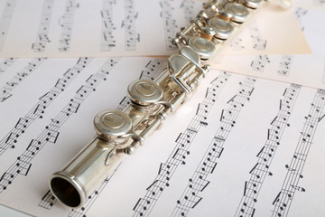 Flute on music notes background