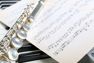 Flute and piano with music sheet close up