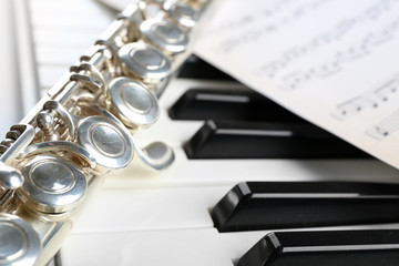 Fototapeta premium Flute and piano with music sheet close up