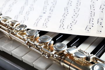 Obraz premium Flute and piano with music sheet close up