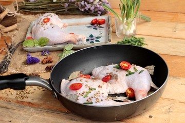 Fresh chicken and tomatoes with spices for cooking