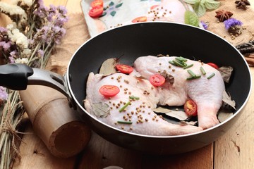 Fresh chicken and tomatoes with spices for cooking