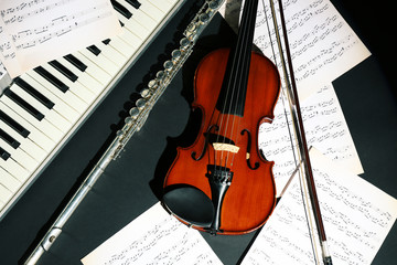 Fototapeta premium Musical instruments with music notes on dark background