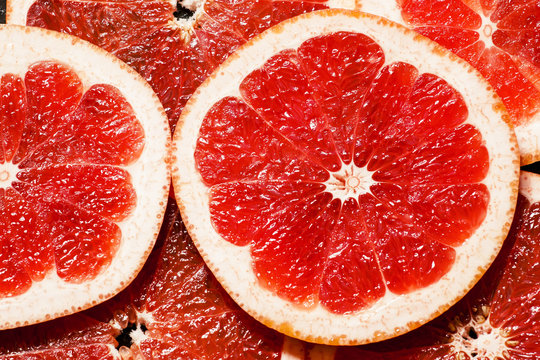Slices of red grapefruit, top view, selective focus