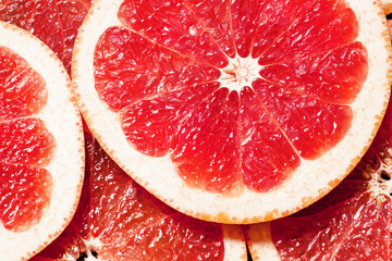 Slices of red grapefruit, top view, selective focus