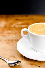Coffee cup with a spoon on the wood table