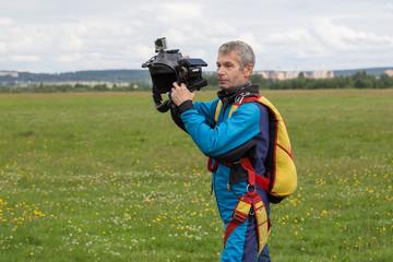 Air videographer with a helmet and a camera in hand