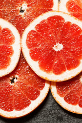 Slices of red grapefruit, top view, selective focus