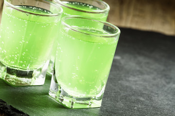 Green cocktail witn gin and mint, selective focus