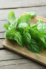 Green fresh basil on wooden background