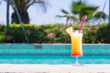 Glass of Cinderella kids cocktail near the pool