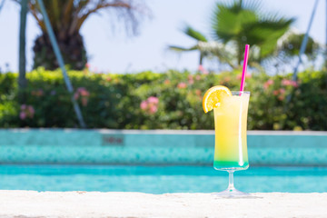Glass of Happy days cocktail near the pool