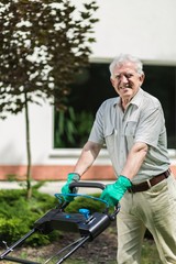 Elder gardener with lawn mower