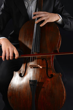 Man playing on cello close up