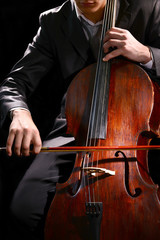 Man playing on cello close up