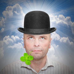 Happy successful businessman in bowler hat taking a selfie on his holidays.