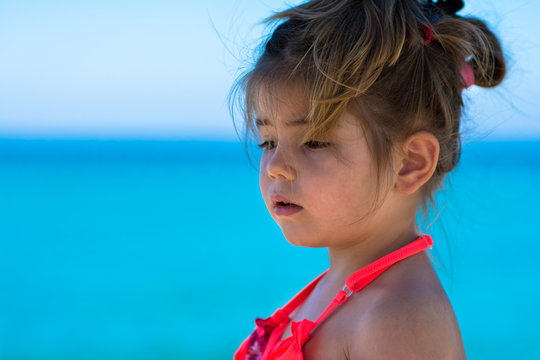 Cute little girl, blue sea background