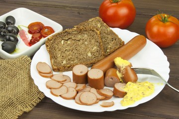 Poultry sausages on a wooden table, preparing home-made snacks. Ingredients for seasoning sausages.
