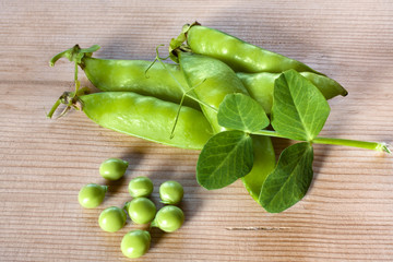 fresh green peas on wooden table