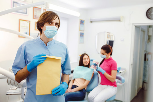 dentist with documents in hands