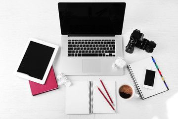 Office supplies and gadgets on white table, top view