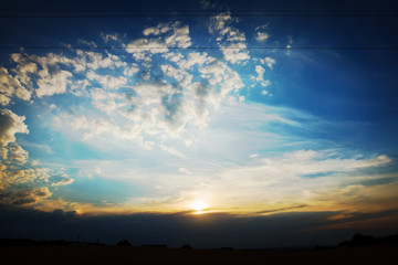 A dreamy sunset over the village with dramatic cloudscape.