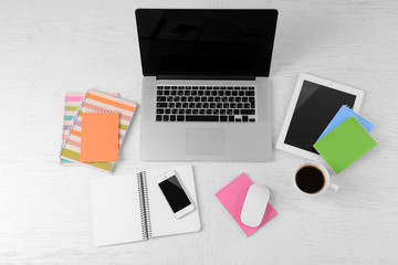 Office supplies and gadgets on white table, top view