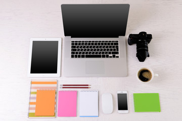 Office supplies and gadgets on white table, top view