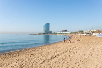 The beach of Barceloneta early morning. In the background the huge Barcelona-W hotel. The beach is in close to down town and very famous in Barcelona