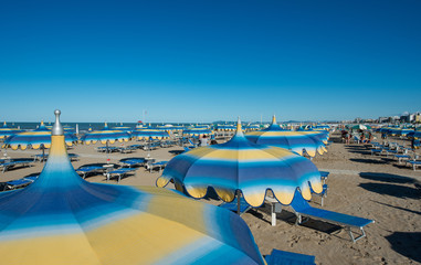 Fototapeta na wymiar Beach chairs and unbrella at Rimini beach