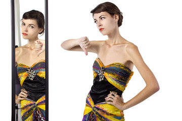 woman wearing a dress with her thumbs down while looking at a mirror