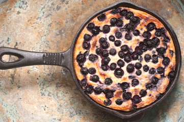 Cottage cheese casserole Cheesecake with blueberries in pan. top view