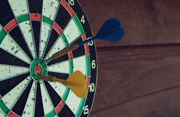 Darts arrows in the target center.