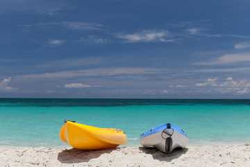 Two small boats ( Canoe, kayak ) stay on the sea front