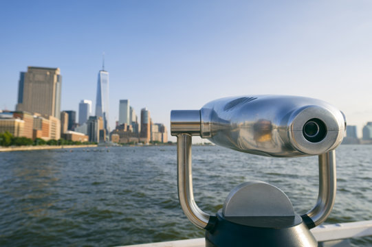Classic telescope looks out over Hudson River Skyline view of Downtown Manhattan New York City