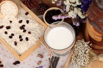 Obraz na płótnie Canvas Oat flakes with currant dried fruit and milk