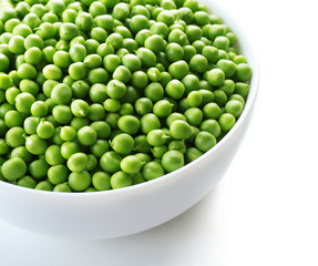 Fresh green peas in bowl isolated on white