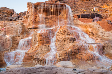 The waterfall on red rock in Egypt at summer
