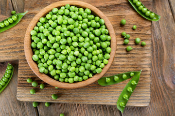 Fresh green peas in bowl on table close up