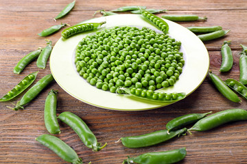 Fresh green peas in bowl on table close up