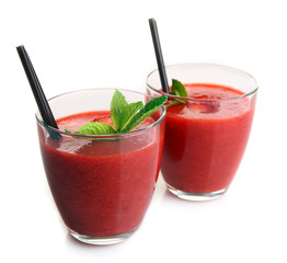 Glasses of strawberry smoothie with mint isolated on white