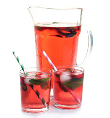 Full jug and glasses of strawberry juice isolated on white