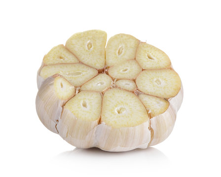 Head of garlic cut in half on white background