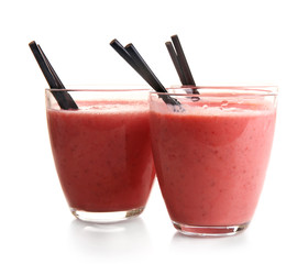 Glasses of milkshake with strawberries isolated on white