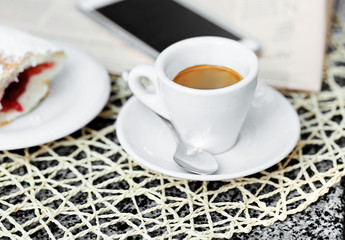 Cup of cappuccino on table in cafe