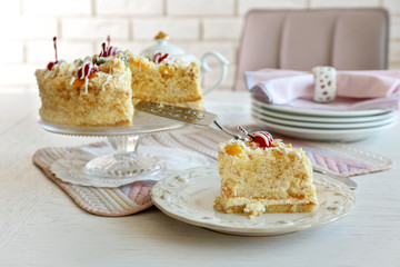 Peace of tasty Butter cake on plate, on color wooden background