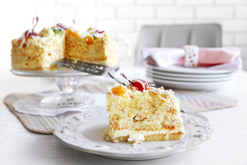 Peace of tasty Butter cake on plate, on color wooden background
