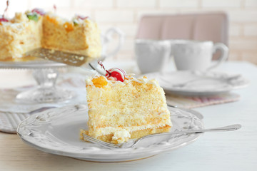 Peace of tasty Butter cake on plate, on color wooden background